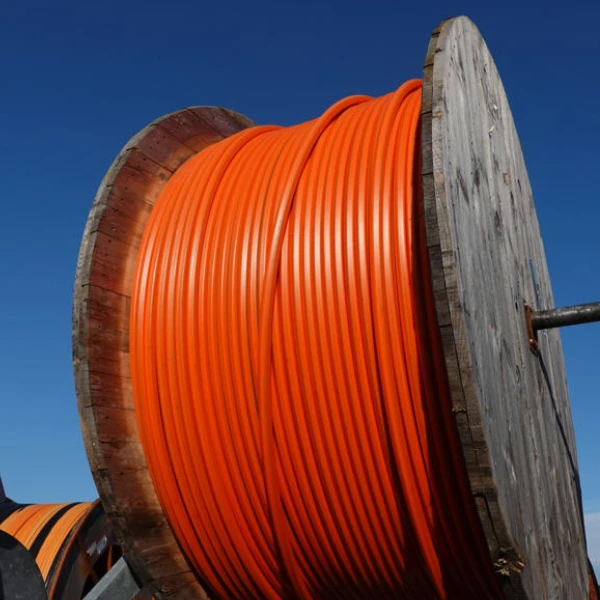 Large roll of orange HDPE conduit