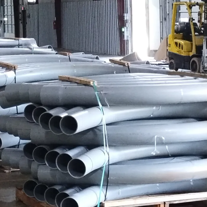 Pallets of PVC electrical conduit elbows staged in warehouse