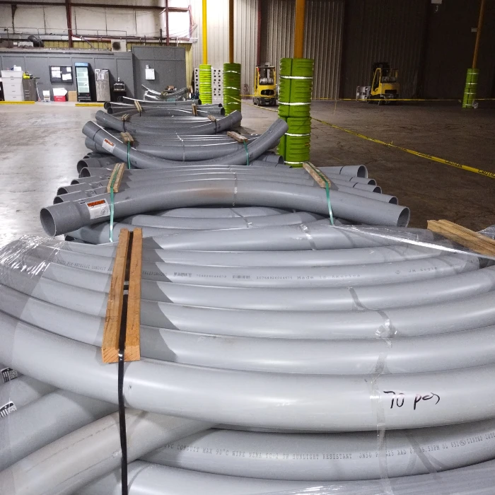 Pallets of PVC conduit elbows staged in warehouse